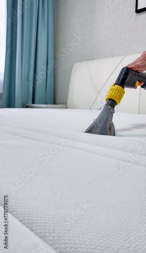 The concept of cleaning and housekeeping. Dry cleaning of the mattress by a professional method.