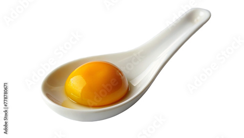 Egg yolk on white spoon isolated on transparent