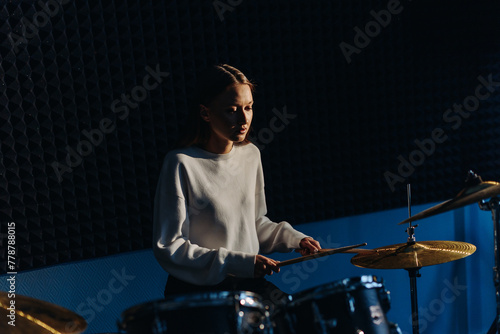 young woman playing drum set