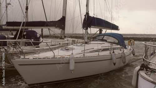 A 10m sailing yacht moored in the dock to a pontoon during a gale force storm
