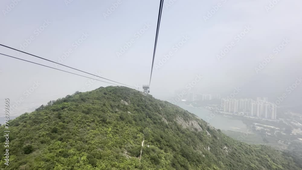Ngong Ping 360 connects Tung Chung and Lantau Island with the longest cable-stayed cable car system Visitors can enjoy superb sea and mountain views blue sea and the city of Hong Kong in the distance Ngong Ping 360 connects Tung Chung and Lantau Island with the longest cable-stayed cable car system Visitors can enjoy superb sea and mountain views blue sea and the city of Hong Kong in the distance