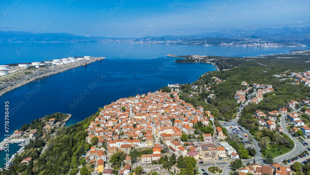 Omišalj, a charming old town perched on a cliff overlooking the Adriatic Sea, is situated on the picturesque Krk Island in Croatia captured from a drone