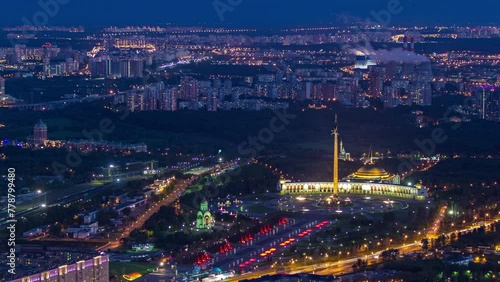Aerial top view of Moscow city day to night timelapse after sunset. From the observation platform of the business center. Illuminated Victory Museum at park on Poklonnaya Hill. Traffic on Kutuzov ave
