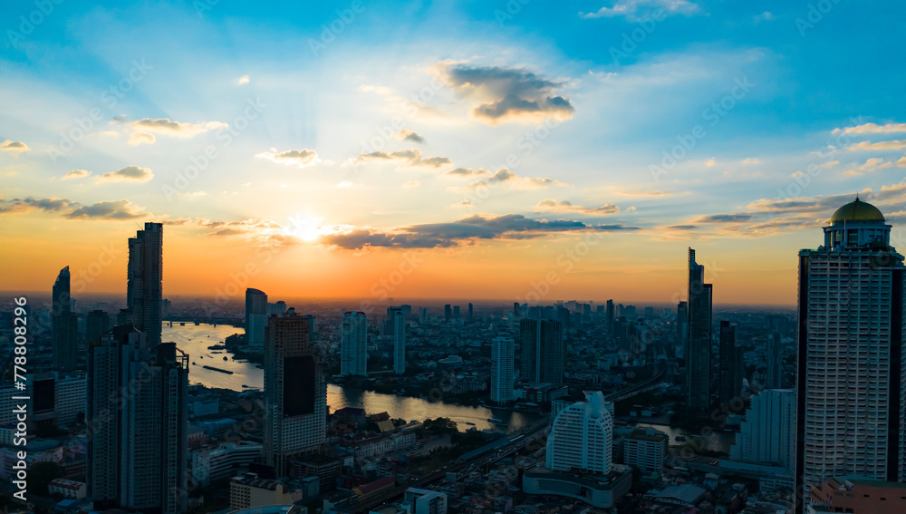 The sunset view with Bangkok skyline and skyscraper with the river on Sathorn Road center of business downtown.