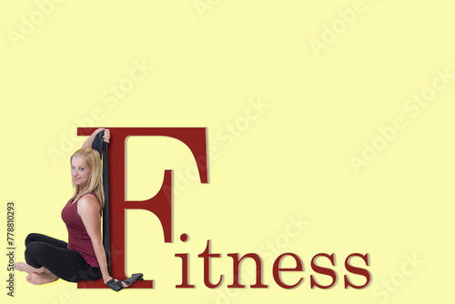 Exercising young woman is leaning on the letter F in the name Fitness and is looking at the camera. All on a yellow background.