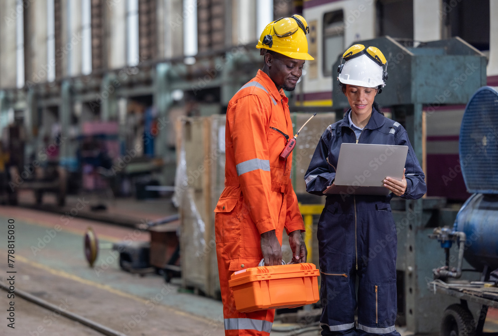 Engineer supervisor uses laptop for train diagnostics, maintenance, and CO2 reduction discussions. Engineer supervisor uses laptop for train diagnostics, maintenance, and CO2 reduction discussions.