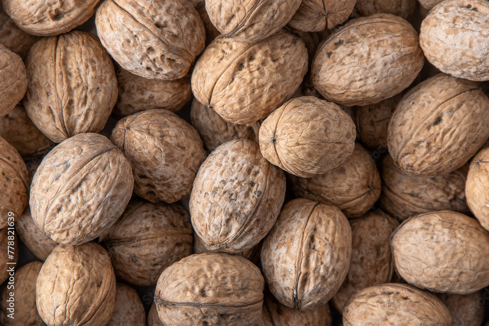 Walnut in shell. Background view from above. Healthy food top view Walnut in shell. Background view from above. Healthy food top view