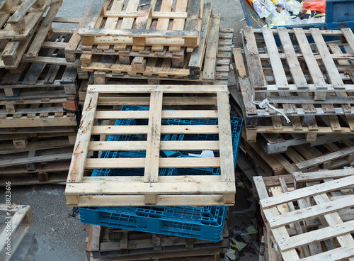 worn-out wooden pallets, thrown into the street, written off and not used, lying like trash photo