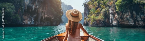 Back view of a woman on a boat trip admiring towering limestone cliffs. © Creative_Bringer
