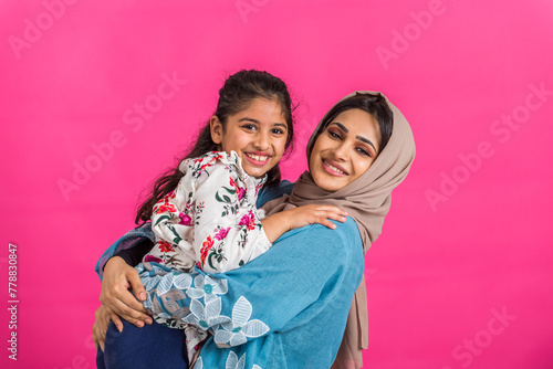 Portrait of middle eastern mother and daughter wearing traditional abaya
