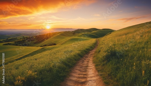 A picturesque path winding through rolling hills under a radiant sunset, evoking a sense of peace and the beauty of the countryside © video rost