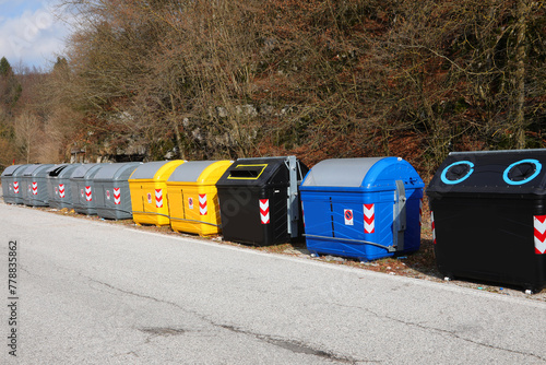 waste and recyclable material bins on the roadside in a city photo