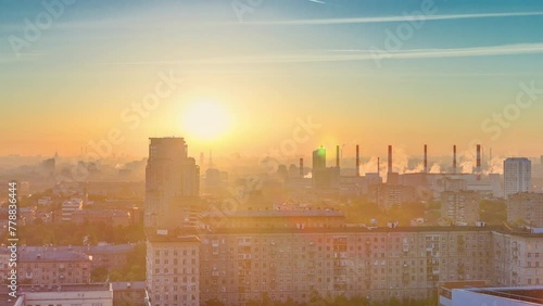 Residential buildings on Leninskiy avenue, Stalin skyscrapers, smoking pipes and panorama of city at sunrise timelapse in Moscow, Russia. Morning mist and colorfil sky. Aerial view from rooftop photo