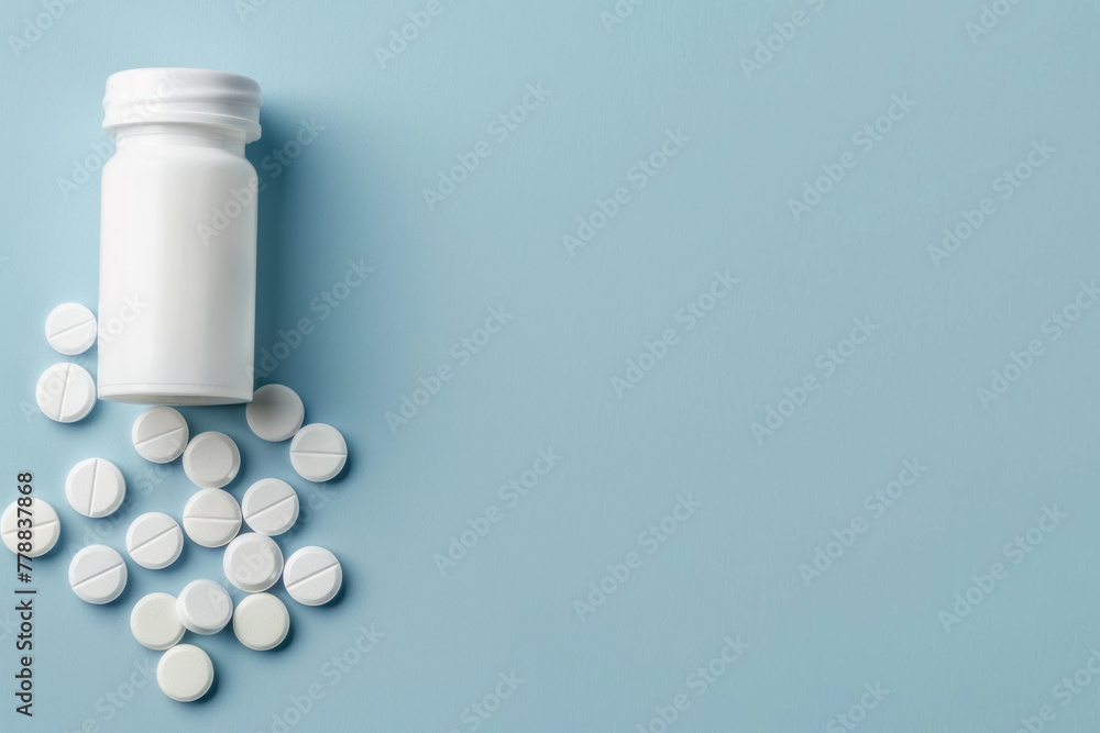 Medicine pills spilled from plastic pill bottle, on blue background. Medicine creative concepts. Flat lay top view, copy space Medicine pills spilled from plastic pill bottle, on blue background. Medicine creative concepts. Flat lay top view, copy space