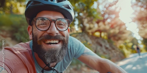 A bearded cyclist in a helmet and glasses smiles. Portrait of a biker in the park. Generative AI.