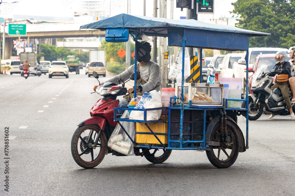  The drinks vendor drives a motorbike with a mobile stand, Bangkok, Thailand