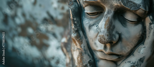 Stone sculpture's serene face, with detailed textures highlighted by natural lighting.