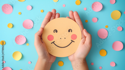 Hands holding happy smile face paper cut, good feedback rating, think positive