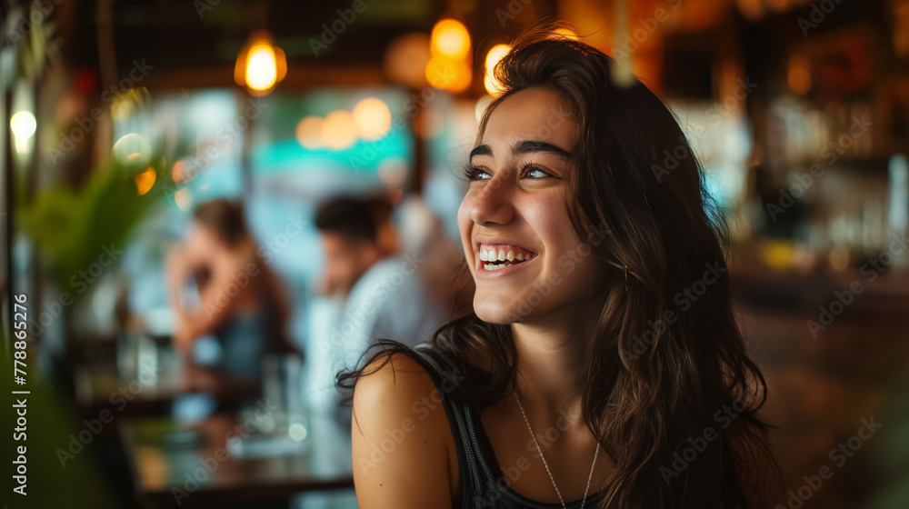 A joyous woman with wavy hair smiles while seated in a lively cafe, with soft focus lights creating a cozy ambiance. A joyous woman with wavy hair smiles while seated in a lively cafe, with soft focus lights creating a cozy ambiance.