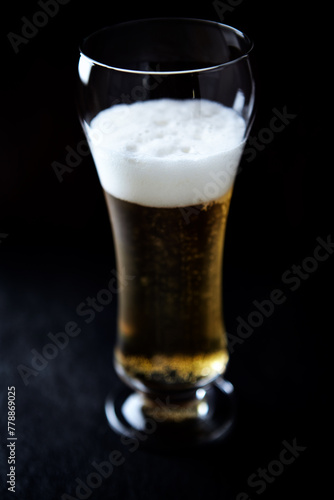 Glass of beer on dark background. Copy space.