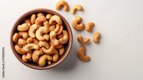 Top view of kaju or cashew nut in a bowl with a big space for text or product in a studio white backdrop, Generative AI. photo