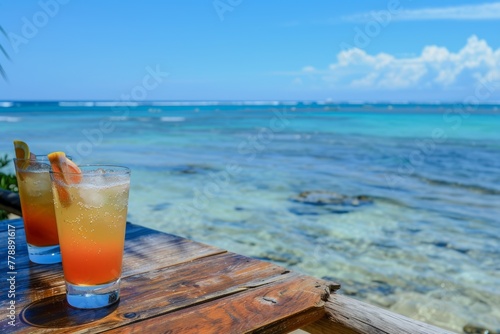 A vibrant beach scene with colorful summer cocktails resting on the sand  overlooking the azure sea