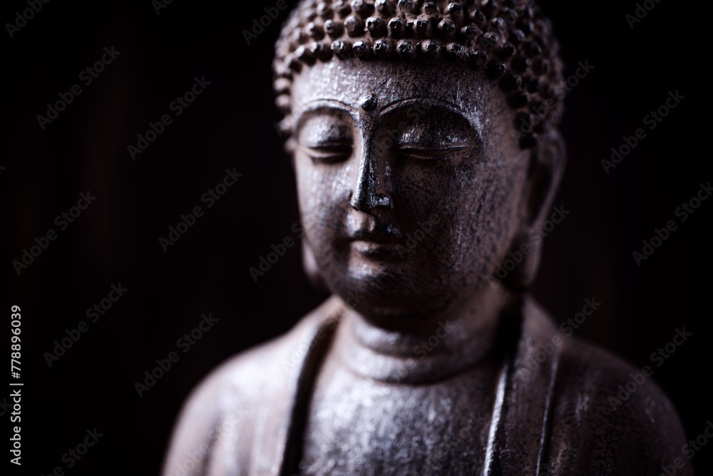 Meditating Buddha Statue on dark background. Soft focus. Close up. Copy space. Meditating Buddha Statue on dark background. Soft focus. Close up. Copy space.