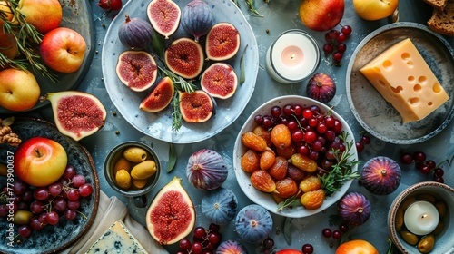  Table topped with fruits, cheese, and a lit candle