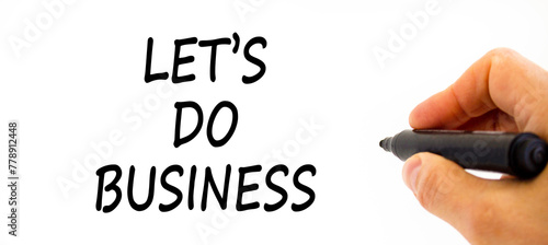 let is do business symbol. Concept words let is do business on beautiful white paper. Beautiful white table white background. Businessman hand. let is do business concept. Copy space. photo