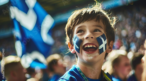 Excited Young Scottish Fan with Flag Face Paint at a Football Match