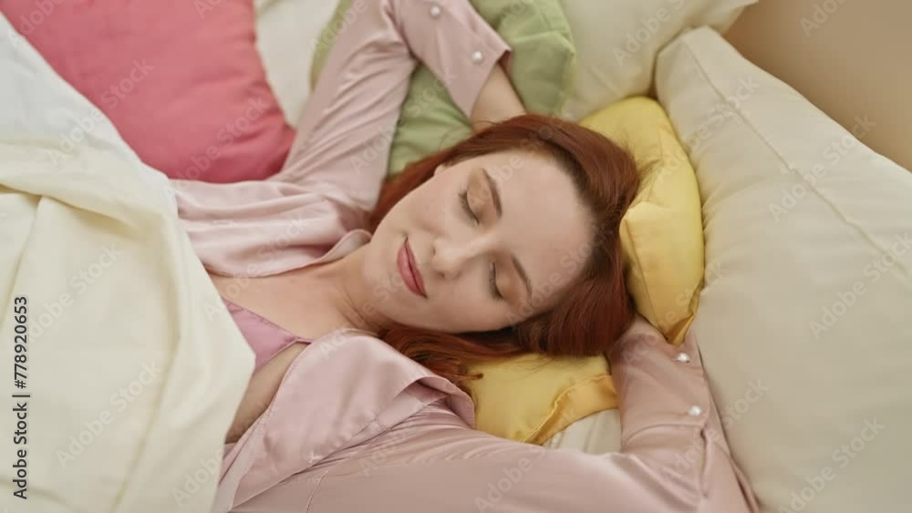 Redheaded woman resting peacefully in a colorful, cozy bedroom, eyes closed with a serene expression. Redheaded woman resting peacefully in a colorful, cozy bedroom, eyes closed with a serene expression.