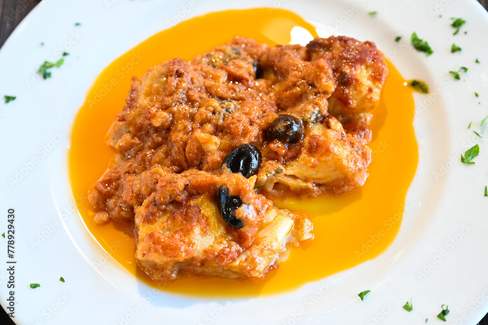 Pollo in potacchio is a regional recipe from Marche region in Italy cooked with tomato sauce, garlic, white wine olives Pollo in potacchio is a regional recipe from Marche region in Italy cooked with tomato sauce, garlic, white wine olives
