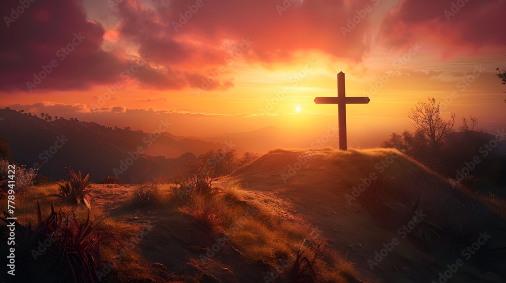 Majestic cross standing proudly atop hill, outlined by golden sunset