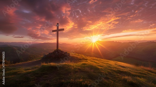 Cross standing on hill against stunning sunset backdrop