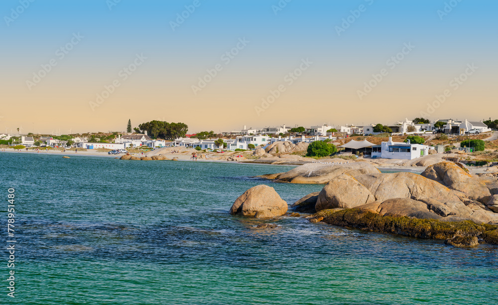 Panorama shot of Paternoster village and the beach with boulders on a blue sky afternoon, Paternoster, South Africa