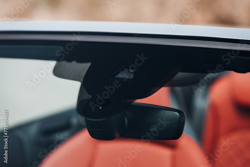 Rain and light sensor on the windshield of the car