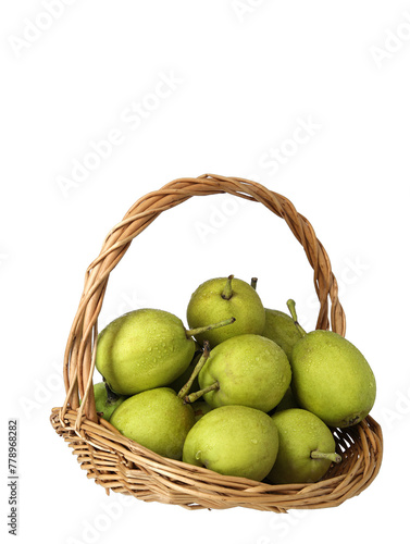 A basket of green fresh fruit pears