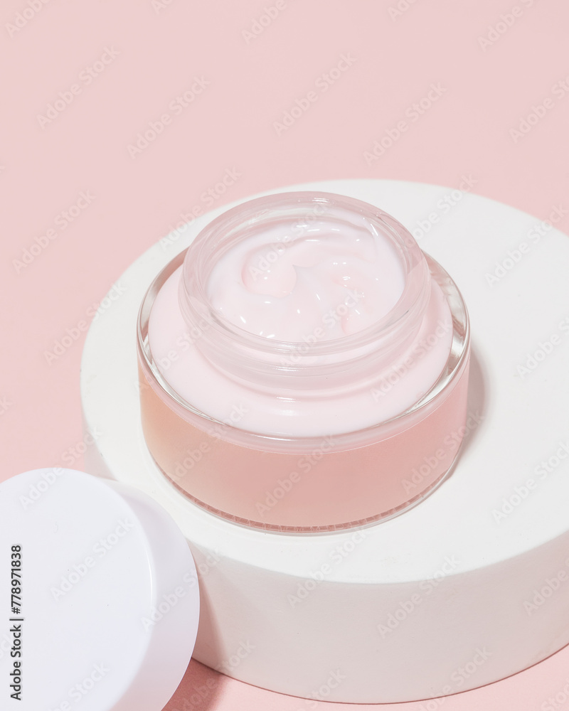 Pink jar of skincare cream on pink background Pink jar of skincare cream on pink background