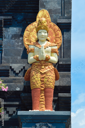 Low Angle Portrait View Of Male Guardian Statue In Front Of The Entrance Gate To Main Area Of Buddhist Temple At Banjar Tegeha, Buleleng, Bali, Indonesia photo