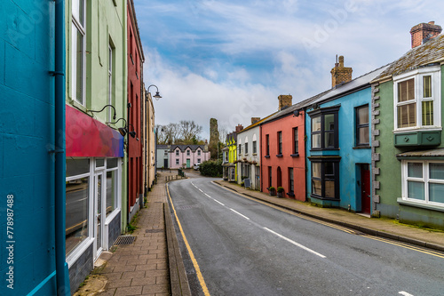 A view past colourful houses towards the castle ruins on the main road into Narberth, Pemborkeshire, Wales in Springtime © Nicola