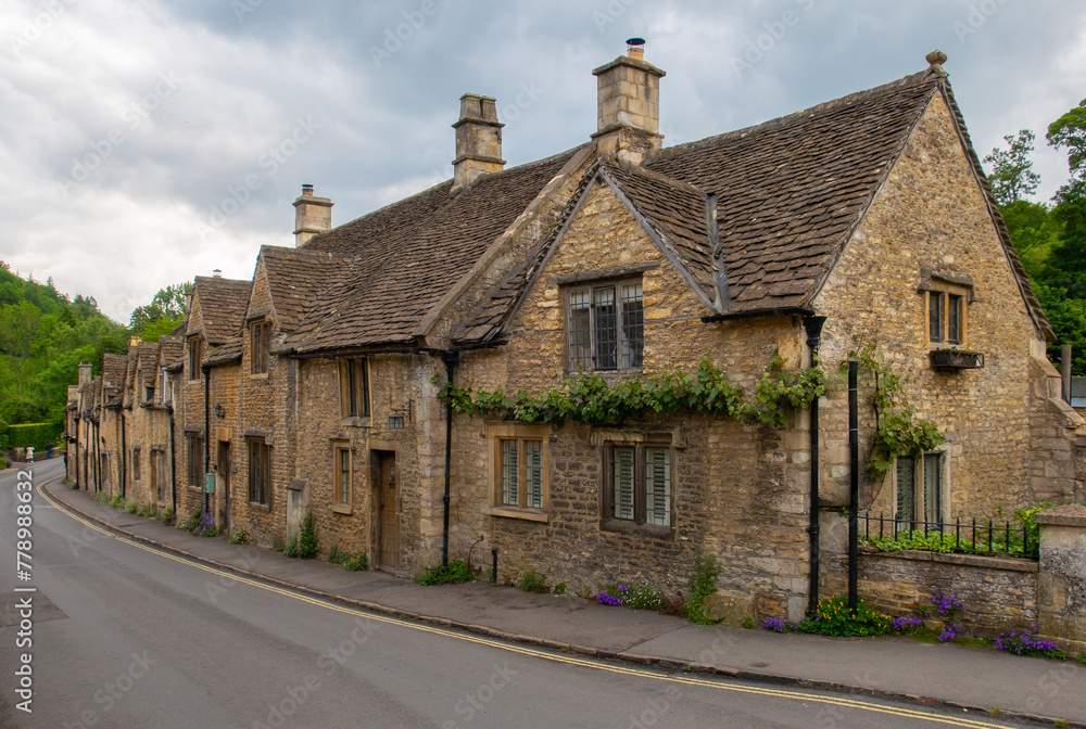 Quaint village street in the Cotswolds area of England Quaint village street in the Cotswolds area of England