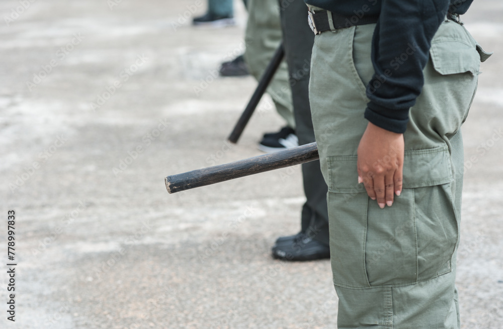 Female riot police practice using batons to control crowds.
Female riot police practice using batons to control crowds.