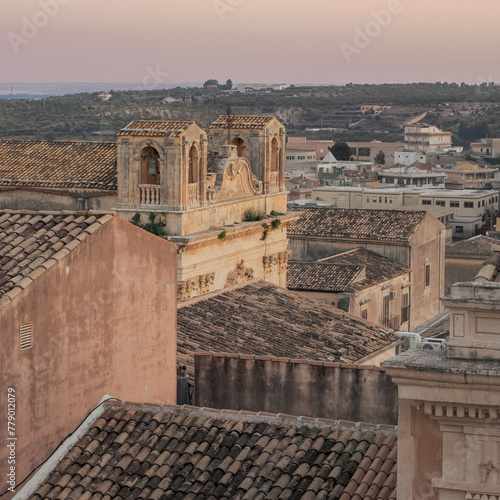 Glimpse over the rooftops of the baroque city of Noto in the light of dusk. Noto, Syracuse, Scily, Italy