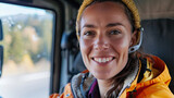 A female truck driver smiling at the camera