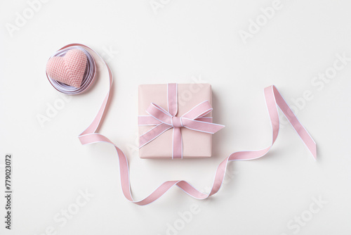Holiday concept greeting card for Birthday, Woman or Mothers Day. Pink heart, ribbon and gift box top view. Flat lay.