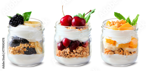 Variety of healthy greek yogurt and fruit parfaits in mason jars isolated on a white background. Blackberry banana, cherry and mango banana.