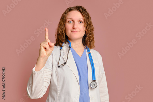 Woman doctor gesture index finger up  studio pink background. Nurse in uniform with stethoscope on red studio background