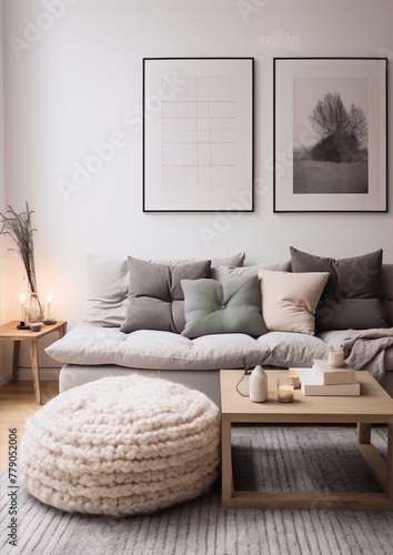 Scandinavian living room interior with white walls  gray sofa  wooden table and soft pouf