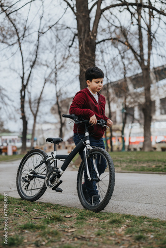 Joyful young boy riding his bicycle outdoors in the park, representing childhood, activity, and happiness.