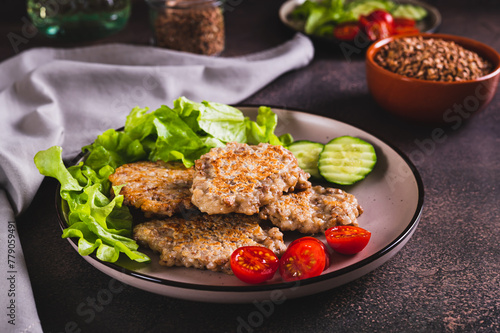 Spicy buckwheat pancakes with slices of cucumber, tomato and lettuce on a plate